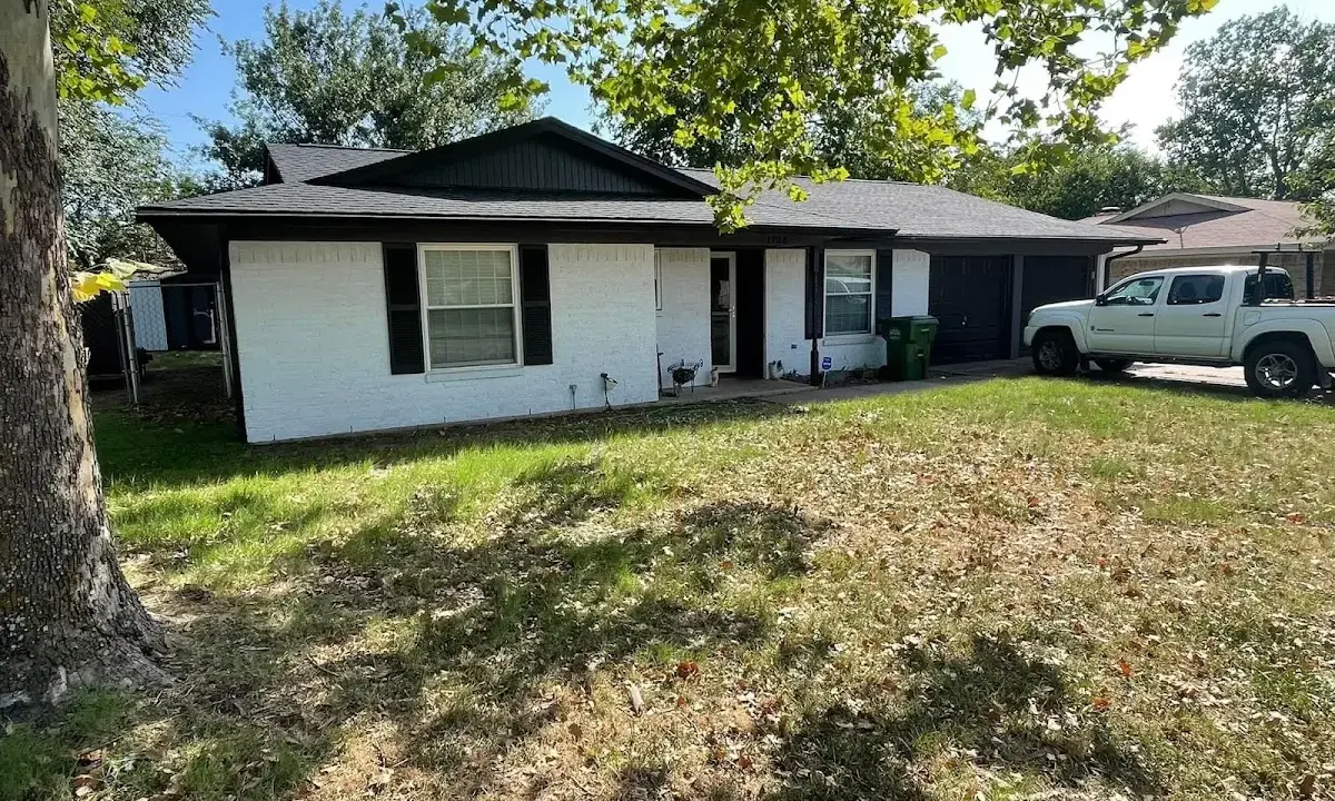 Professional roofing crew working on a residential roof in Loves Park
